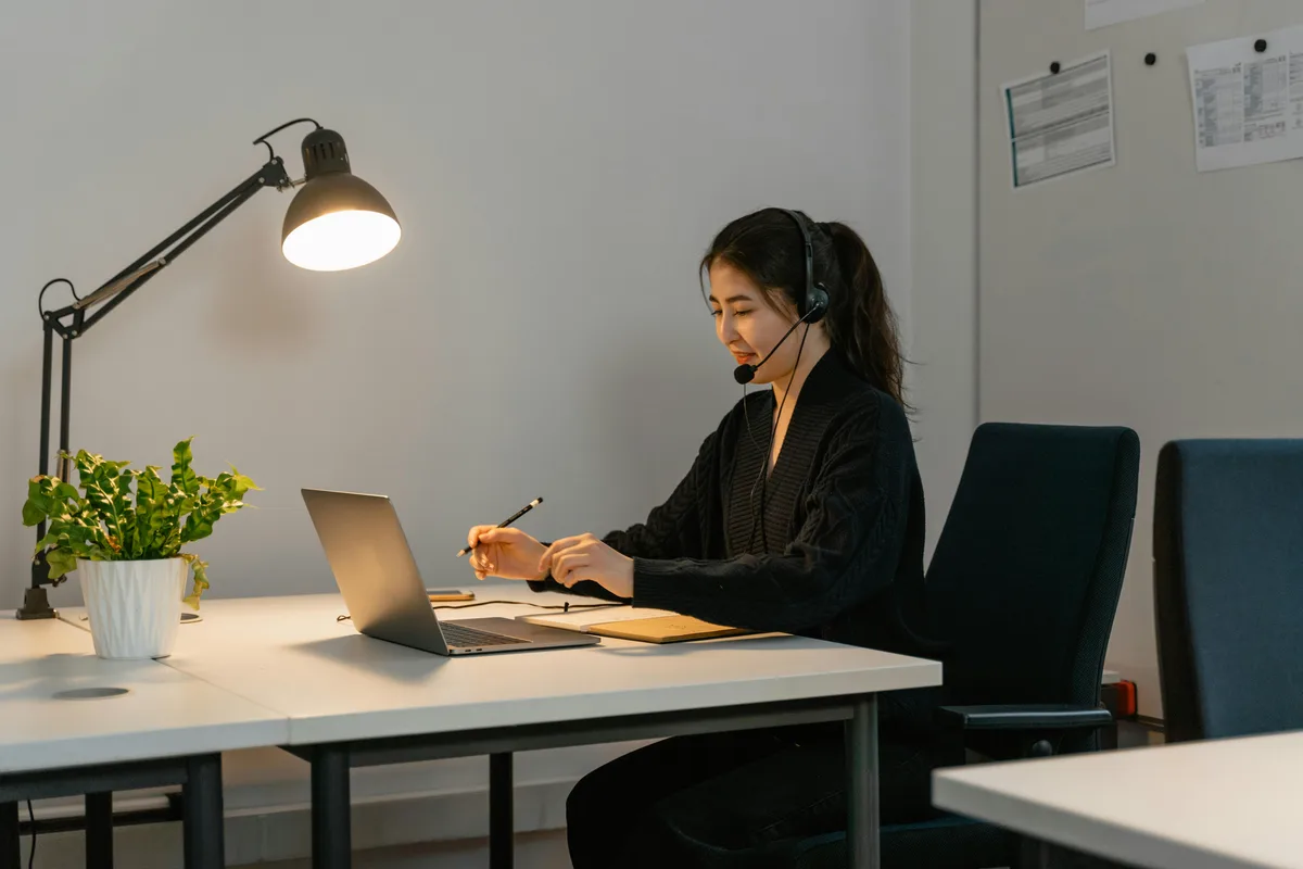 Customer support specialist managing customer inquiries from a laptop workstation